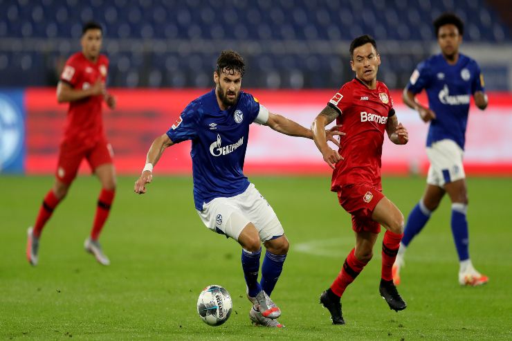GELSENKIRCHEN, GERMANY - JUNE 14: Charles Aranguiz of Leverkusen is challenged by Daniel Caligiuri of Schalke during the Bundesliga match between FC Schalke 04 and Bayer 04 Leverkusen at Veltins-Arena on June 14, 2020 in Gelsenkirchen, Germany.