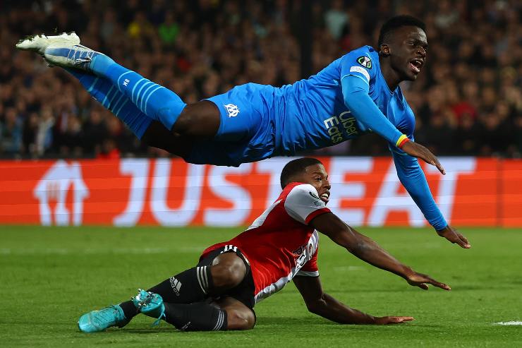 APRIL 28: Bamba Dieng of Marseille is tackled by Tyrell Malacia of Feyenoord during the UEFA Conference League Semi Final Leg One match between Feyenoord and Olympique Marseille at De Kuip on April 28, 2022 in Rotterdam, Netherlands.