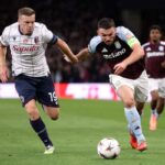 ohn McGinn of Aston Villa is challenged by Lewis Ferguson of Bologna FC 1909 during the UEFA Europa League 2025/26 League Phase MD1 match between Aston Villa FC and Bologna FC 1909 at Villa Park on September 25, 2025 in Birmingham, England.