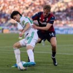 Matías Soulé of AS Roma competes for the ball with Torbjorn Heggem of Bologna FC during the Serie A match between Bologna FC 1909 and AS Roma at Renato Dall'Ara Stadium on April 25, 2026 in Bologna, Italy.