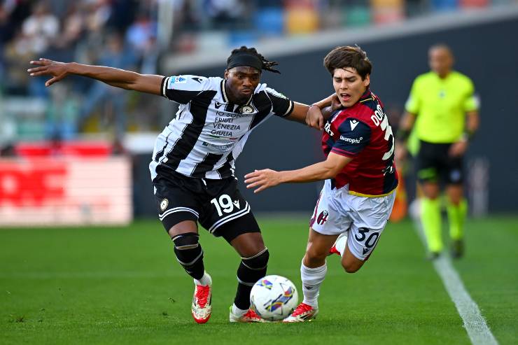 Kingsley Ehizibue of Udinese controls the ball under pressure from Benjamin Dominguez of Bologna during the Serie A match between Udinese and Bologna at Stadio Friuli on April 28, 2025 in Udine, Italy.